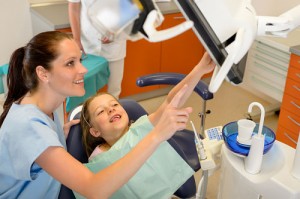 http://www.dreamstime.com/royalty-free-stock-image-dentist-showing-child-dental-procedure-monitor-image25059776